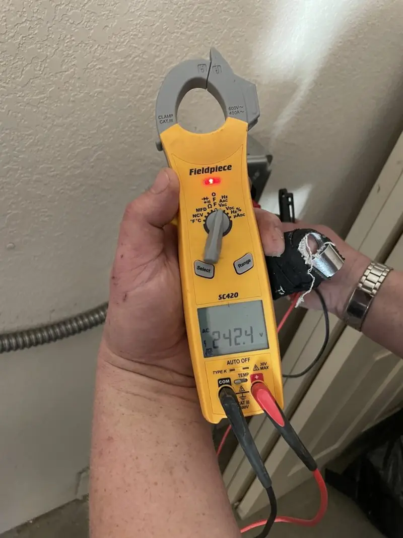 Voltage testing with clamp meter during Recessed Lighting Installation in Peoria Heights